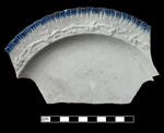 Embossed shell-edged plate with embossed grapevine rim.